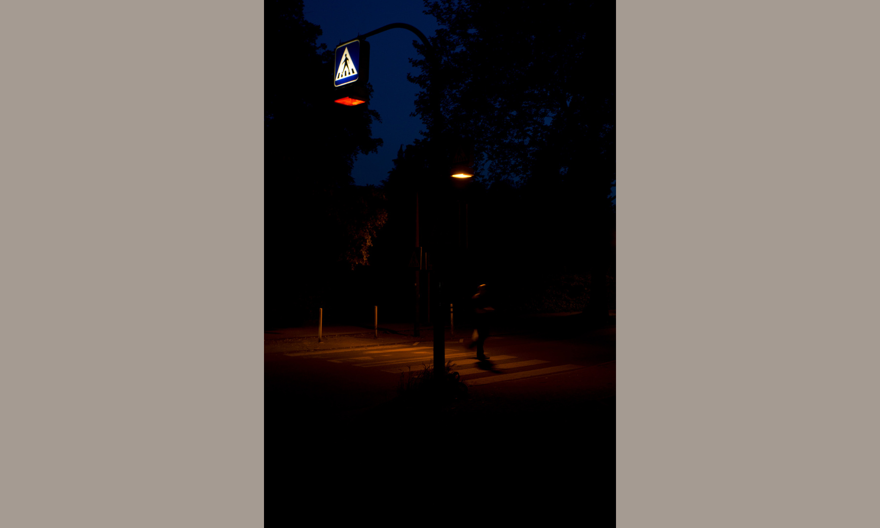 A crosswalk in shades of red at night A crosswalk in shades of red at night