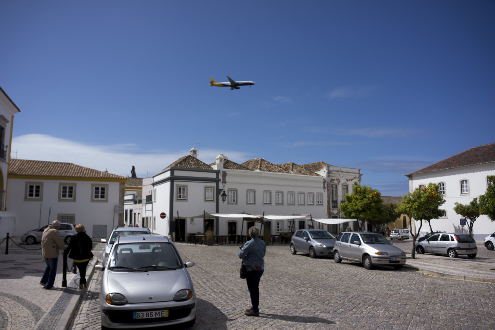 A plane flights over the old city centre of Faro, Portugal A plane flights over the old city centre of Faro, Portugal