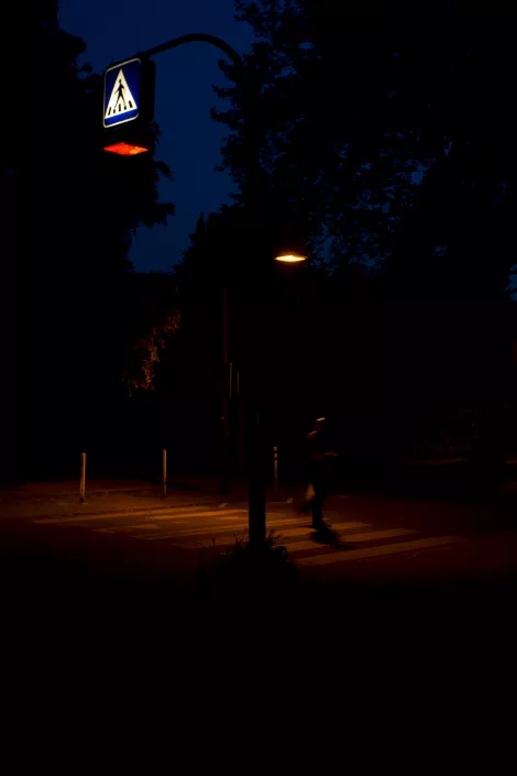 A crosswalk in shades of red at night A crosswalk in shades of red at night