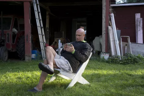 Relaxed person sitting in a chair outside