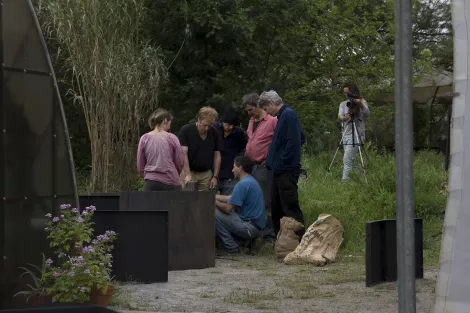 A professor explaining a biogas plant to the audience A professor explaining a biogas plant to the audience