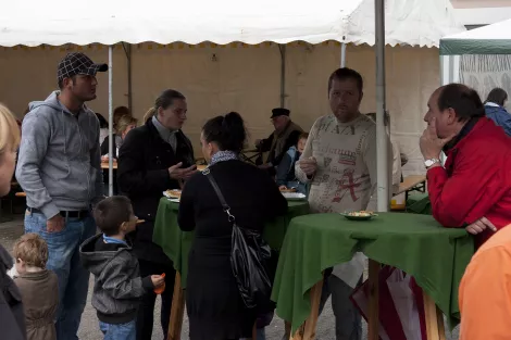 People eating Currywurst at an event in Essen, Germany