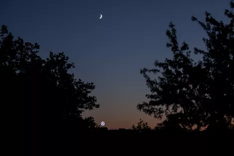 The Mercedes symbol in perfect alignment with the moon. Essen, Germany